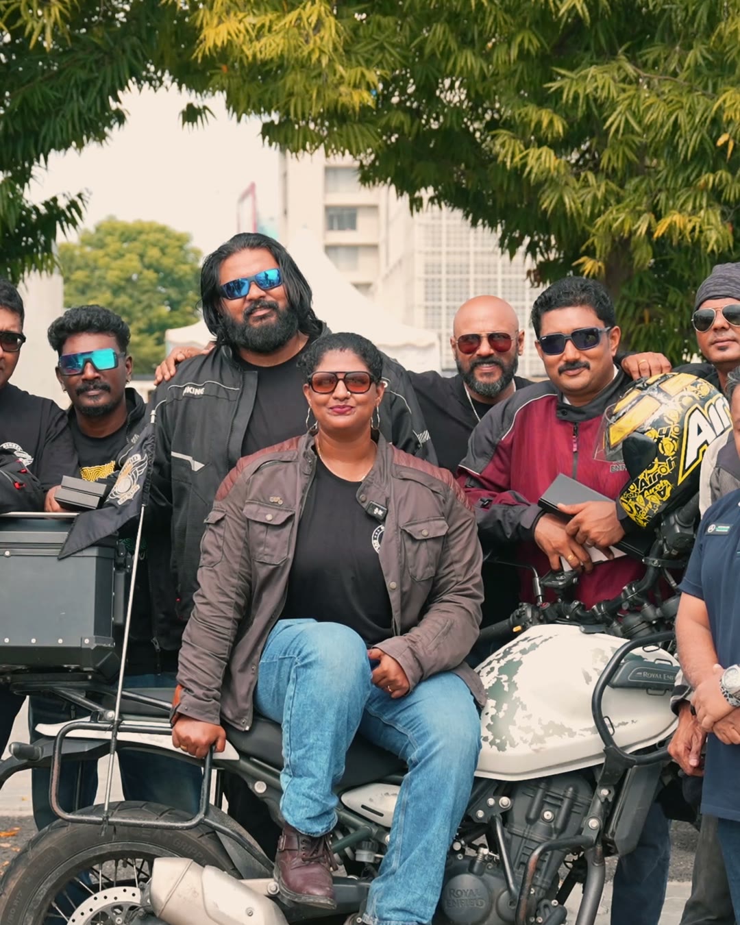 A group of Royal Enfield riders posing with a motorcycle after the One Ride event.
